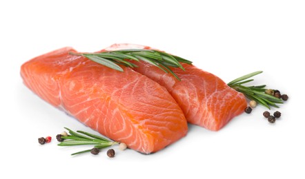 Pieces of fresh raw salmon and spices on white background