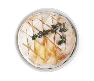 Photo of Tasty baked camembert and thyme in bowl isolated on white, top view