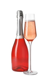 Photo of Bottle and glass of rose champagne isolated on white. Mockup for design