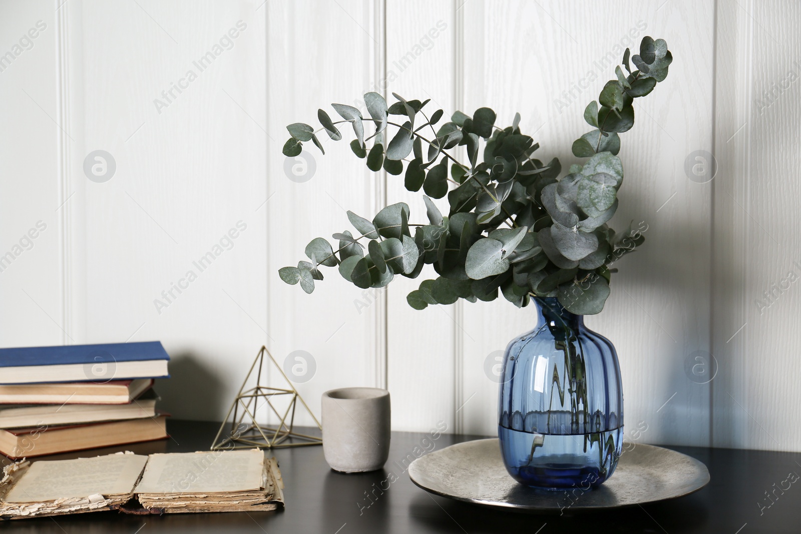 Photo of Composition with eucalyptus branches on black table