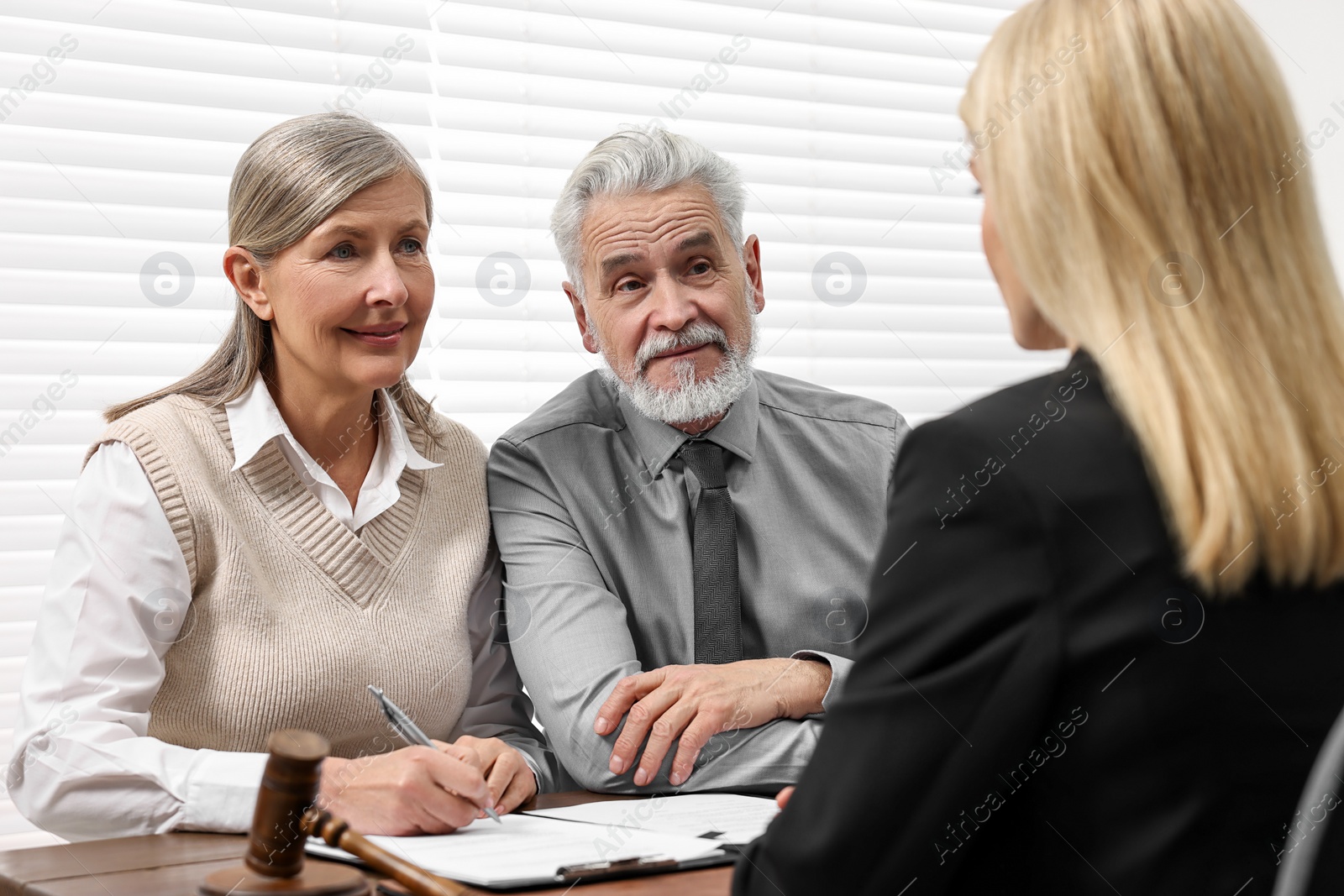 Photo of Senior couple having meeting with lawyer in office