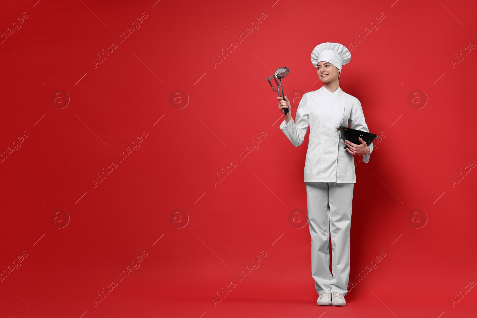 Photo of Professional chef with kitchen utensils on red background. Space for text