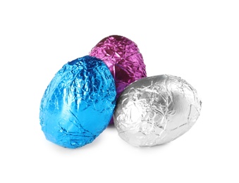 Photo of Chocolate eggs wrapped in colorful foil on white background