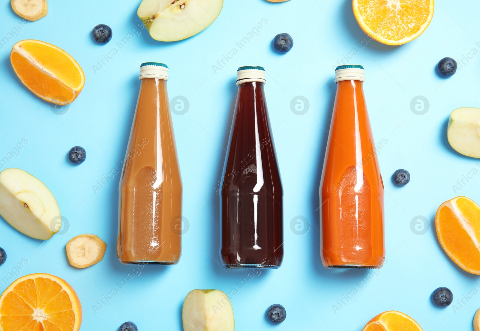 Photo of Flat lay composition with different drinks in bottles and ingredients on color background