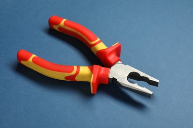 One color combination pliers on blue background