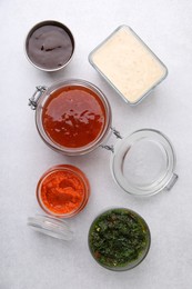 Photo of Different marinades on light table, flat lay