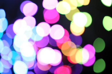 Photo of Blurred view of colorful lights on black background. Bokeh effect