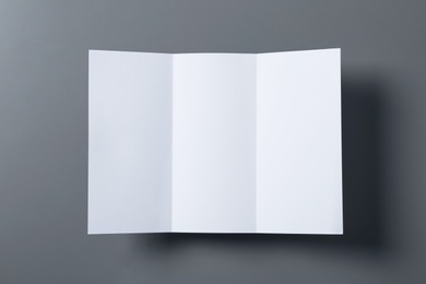 Photo of Empty flyer on grey background, top view. Mockup for design