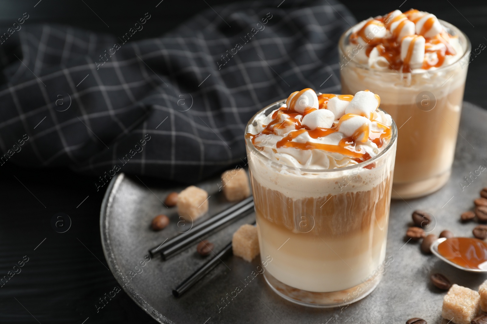 Photo of Glasses with delicious caramel frappe on tray