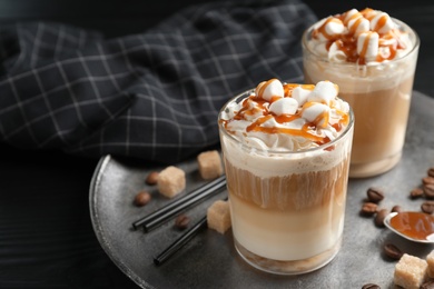 Photo of Glasses with delicious caramel frappe on tray