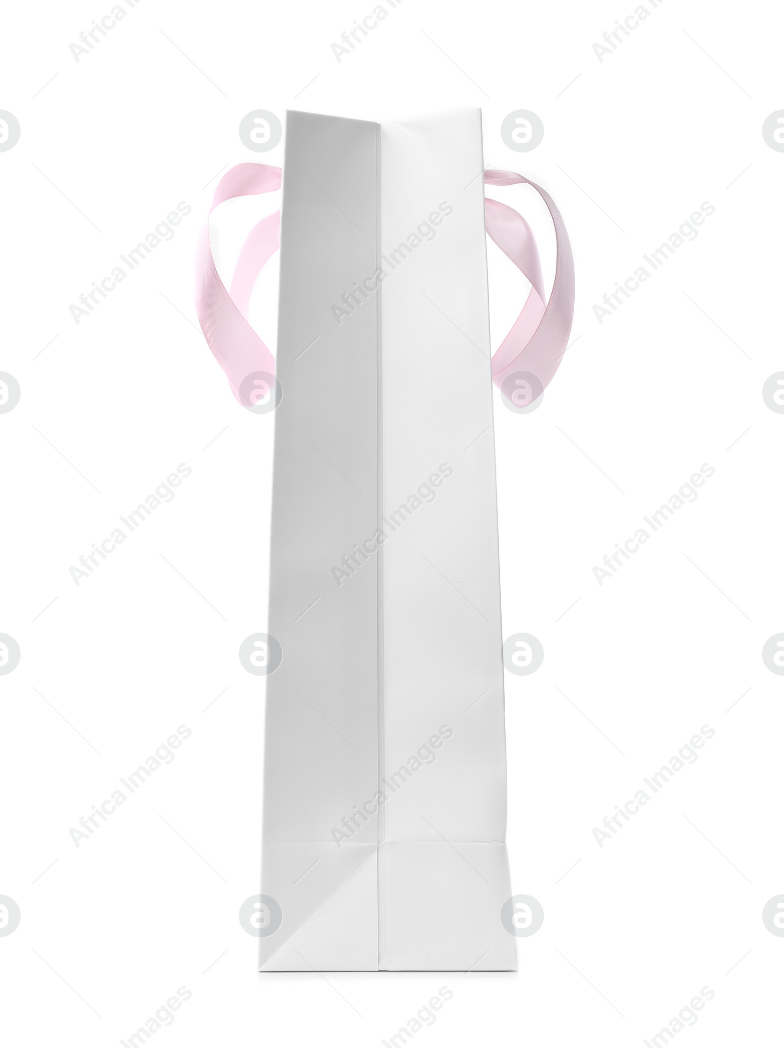 Photo of Paper shopping bag with ribbon handles on white background