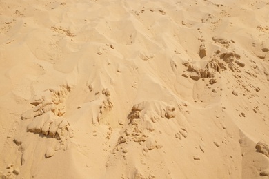 Photo of Dry sand in desert on sunny day as background