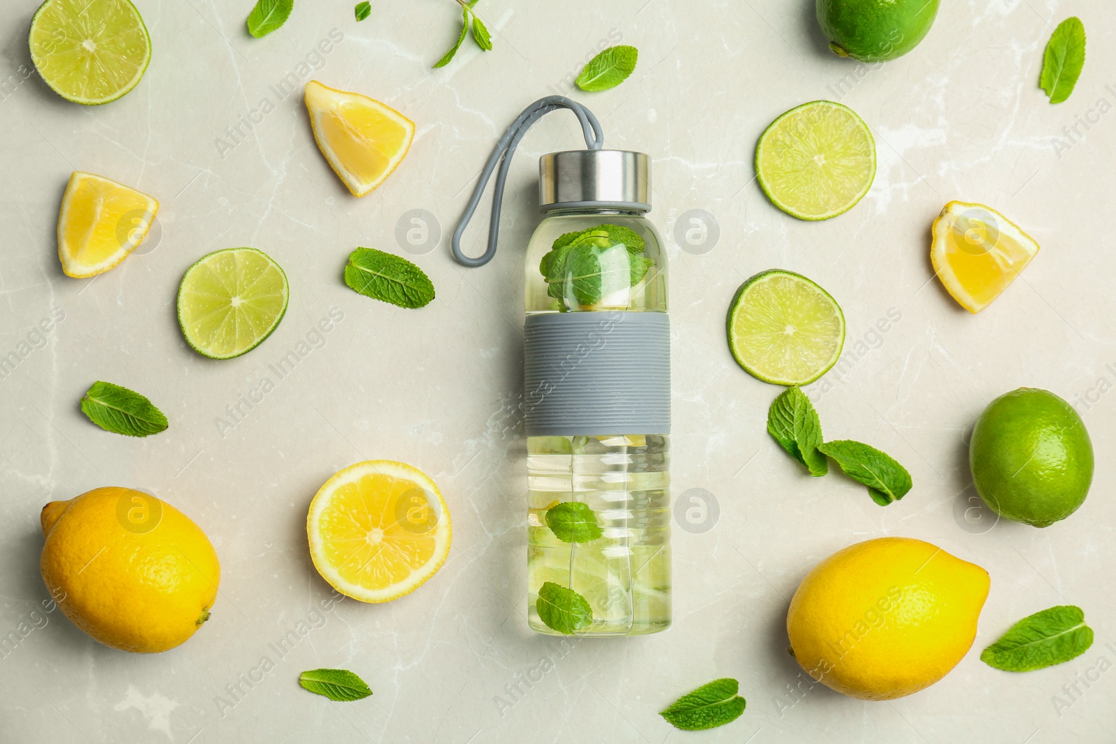 Photo of Flat lay composition with delicious natural lemonade on light background