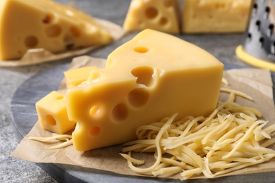 Tasty fresh cheese on grey table, closeup