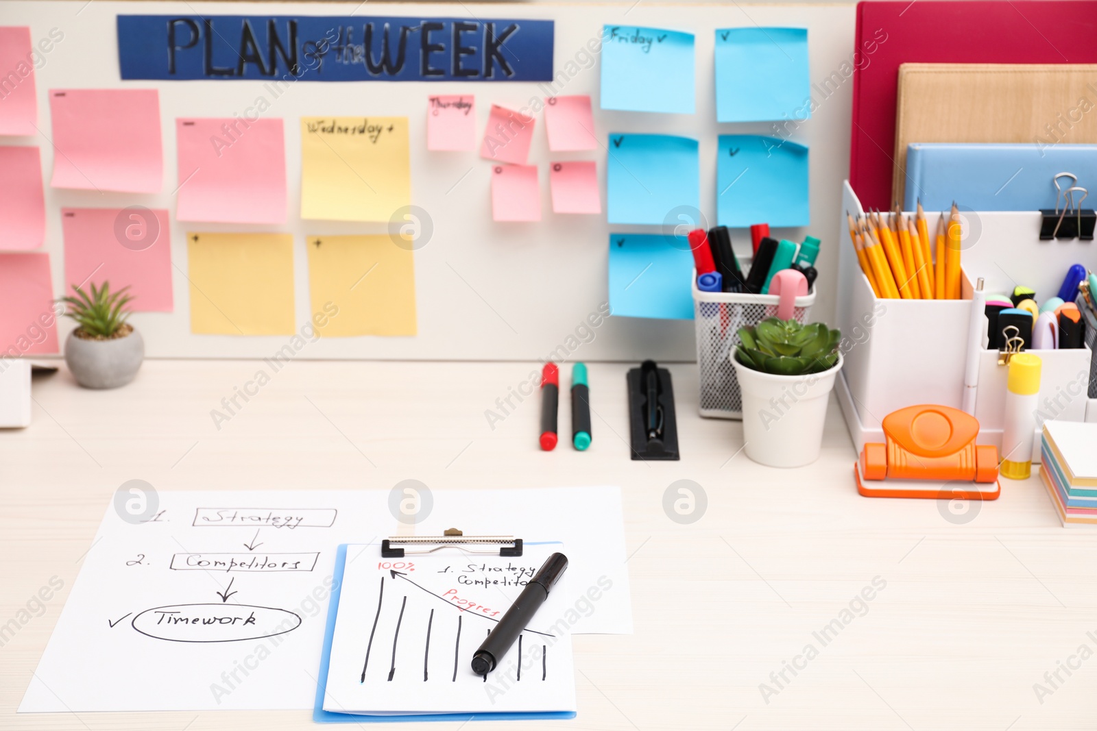 Photo of Business process planning and optimization. Workplace with colorful paper notes and other stationery on white wooden table