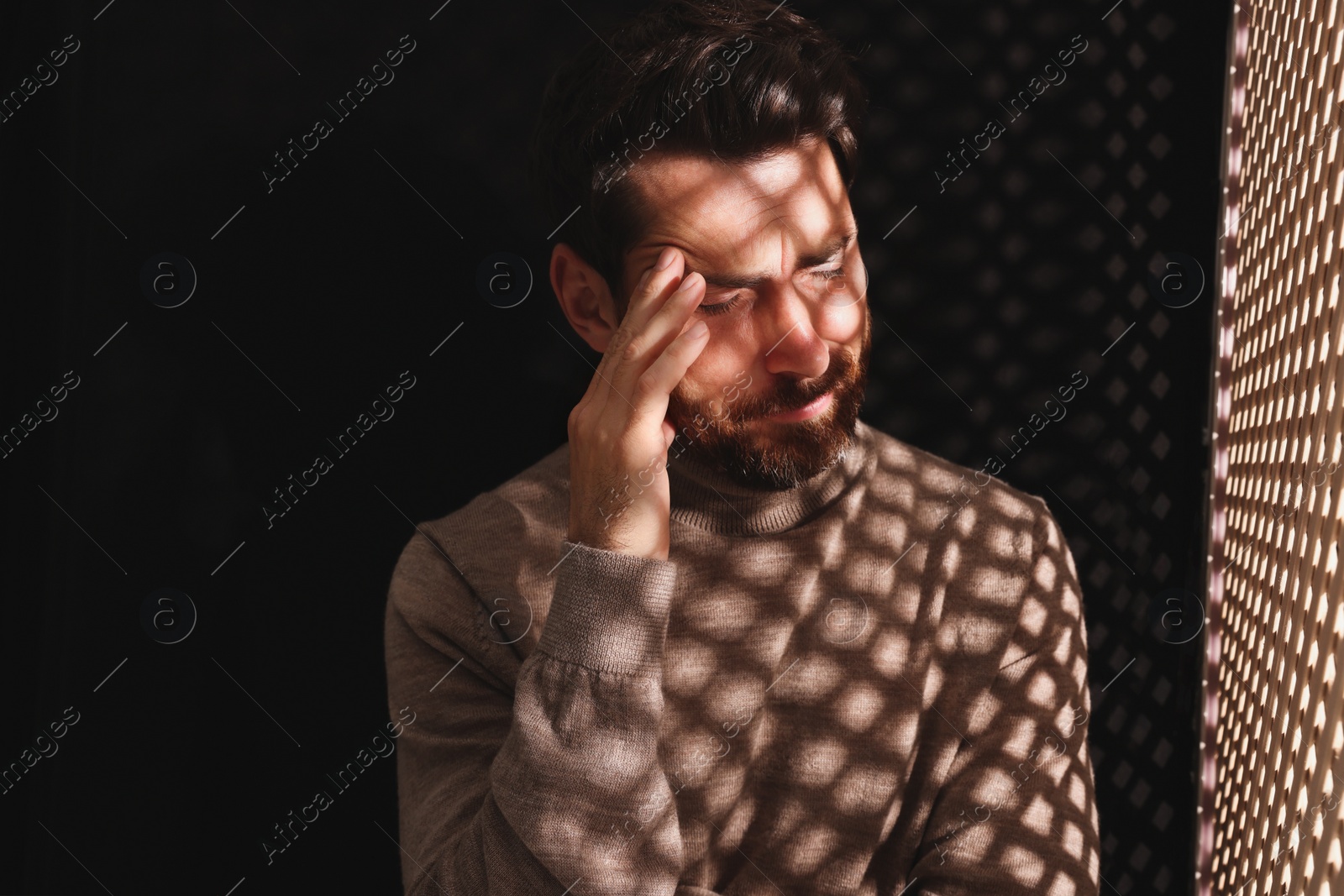 Photo of Upset man listening to priest during confession in booth, space for text