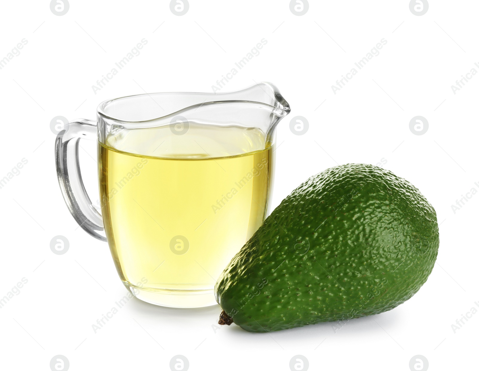 Photo of Jug of natural oil and avocado isolated on white