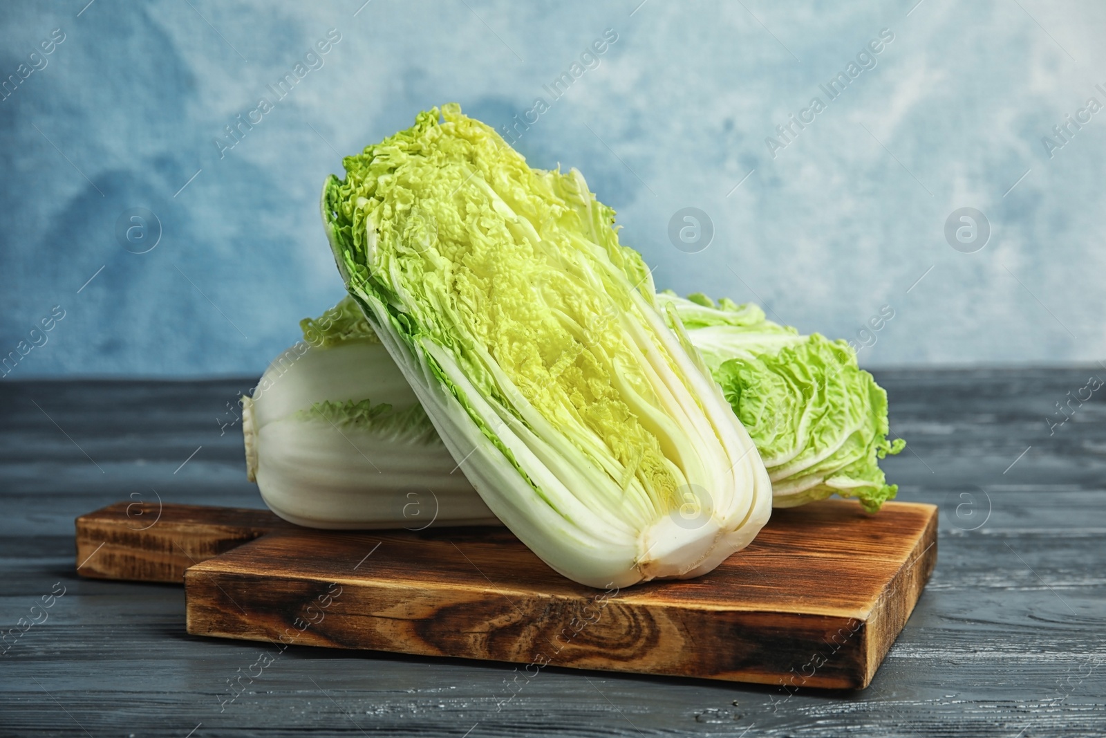 Photo of Fresh ripe cabbages on wooden board