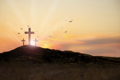 Image of Christian crosses on hill outdoors at sunset. Crucifixion Of Jesus