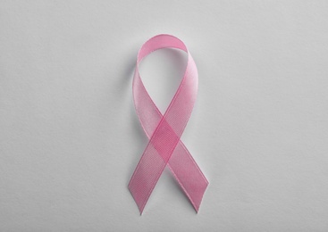 Photo of Pink ribbon on white background, top view. Breast cancer awareness concept