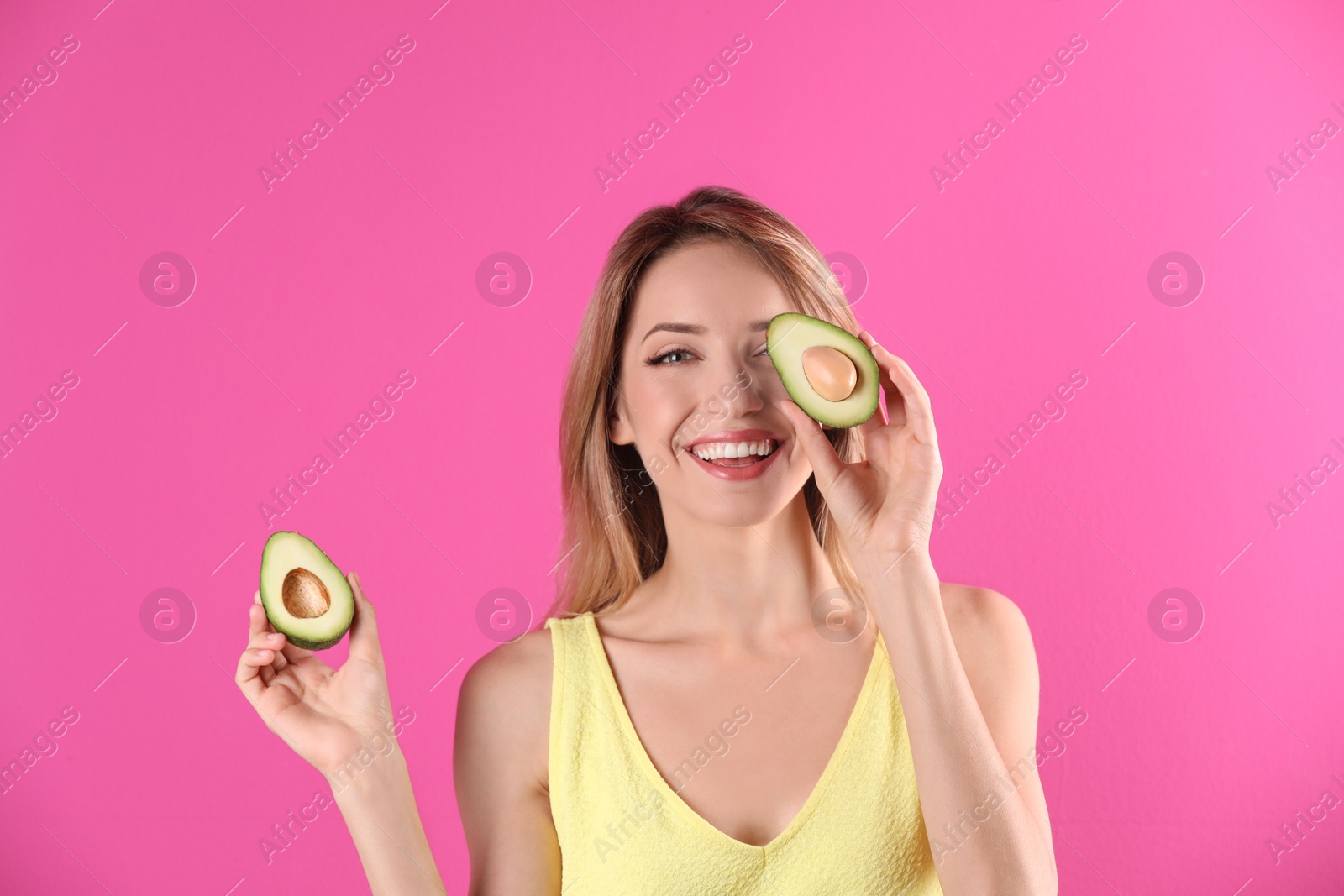 Photo of Portrait of young beautiful woman with ripe delicious avocado on color background