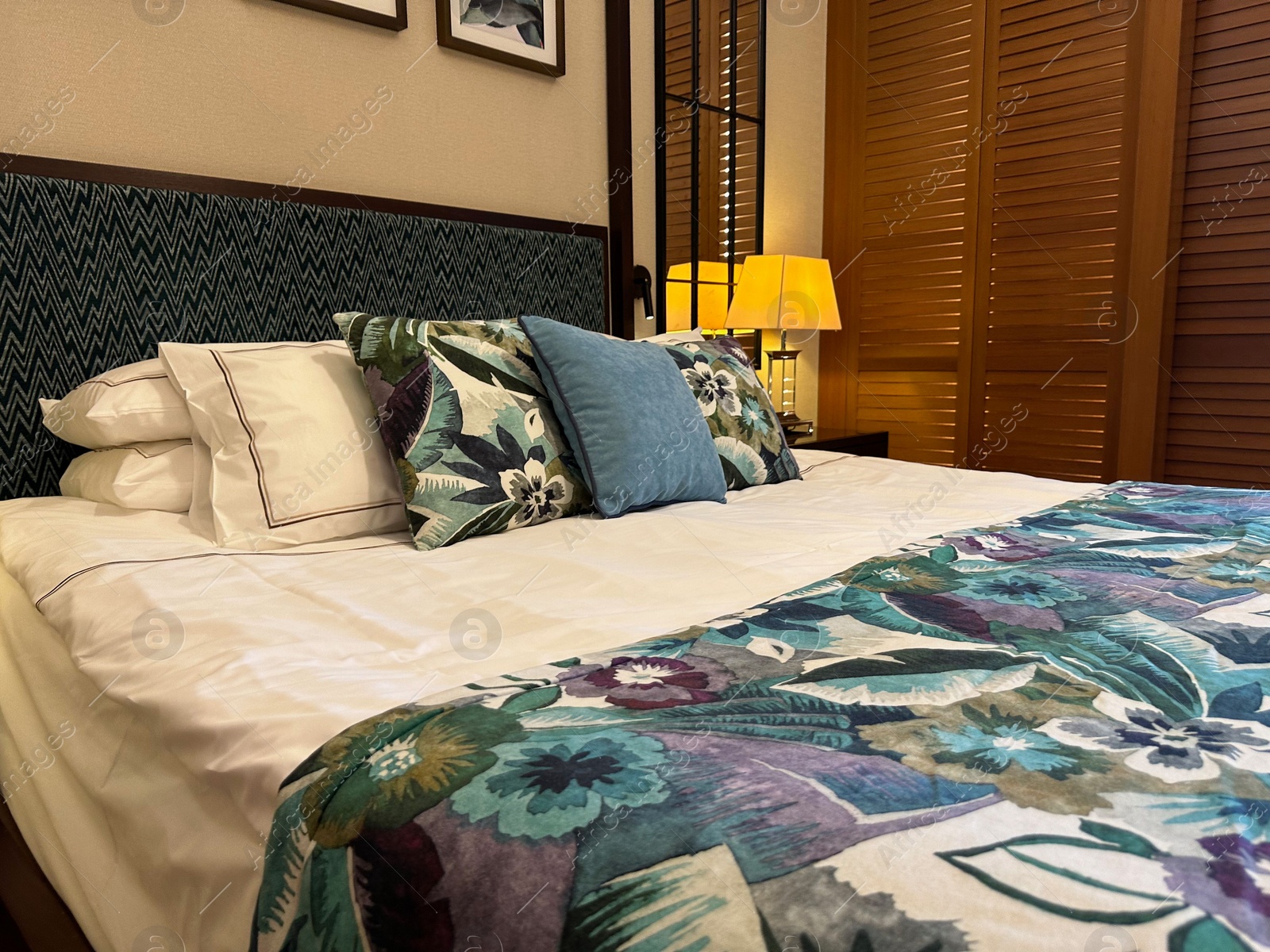 Photo of Large bed with pillows and linens in comfortable hotel room