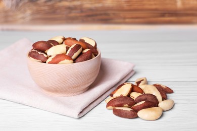 Photo of Many tasty Brazil nuts on white wooden table
