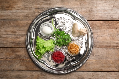Photo of Traditional Jewish plate with symbolic meal for Passover (Pesach) Seder on table, top view