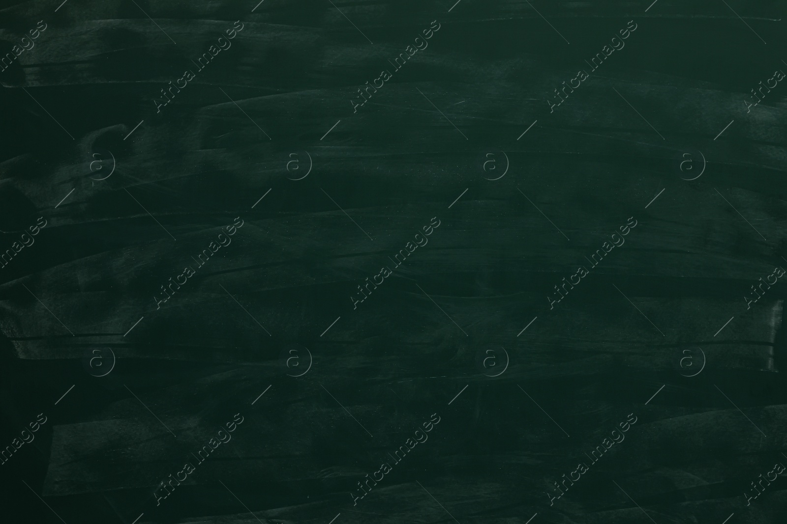 Photo of Chalk rubbed out on green chalkboard as background, closeup. Space for text