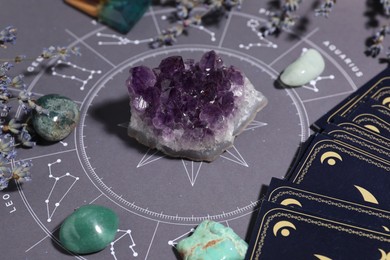 Photo of Astrology prediction. Zodiac wheel, gemstones and tarot cards, closeup