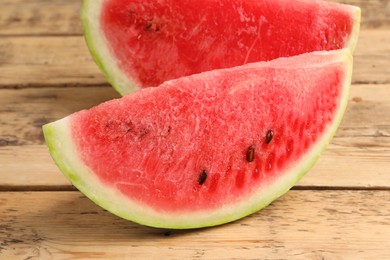 Photo of Delicious fresh watermelon slices on wooden table, closeup