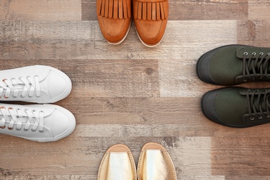 Different female shoes on floor, top view