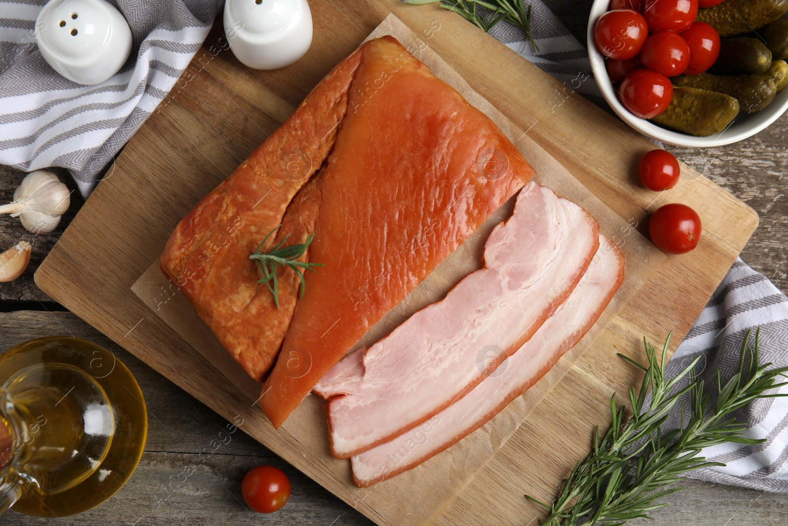 Photo of Flat lay composition with delicious smoked bacon on wooden table