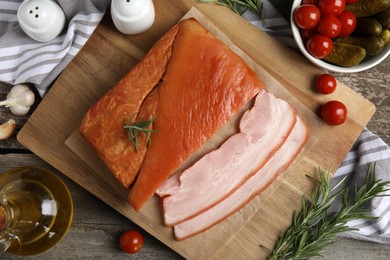 Photo of Flat lay composition with delicious smoked bacon on wooden table