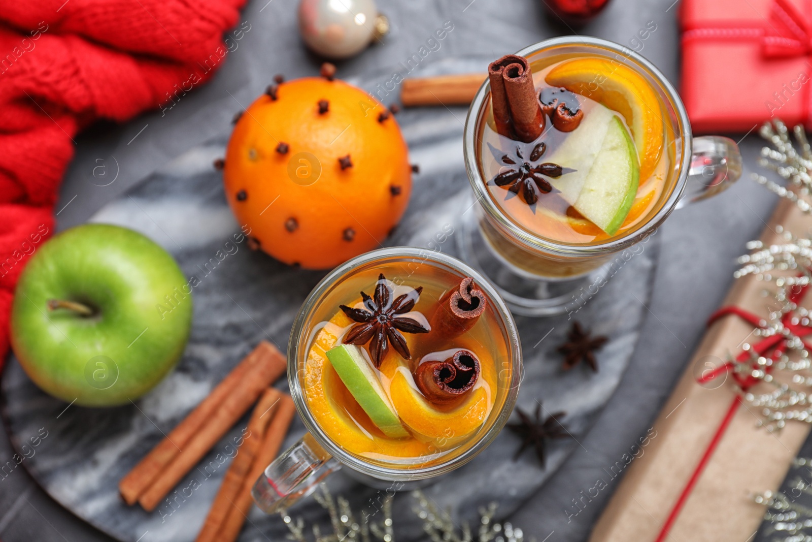 Photo of Aromatic white mulled wine served on grey table, flat lay