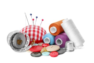 Photo of Spools of threads and sewing tools on white background