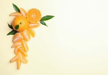 Photo of Composition with tangerines and leaves on color background, flat lay. Space for text