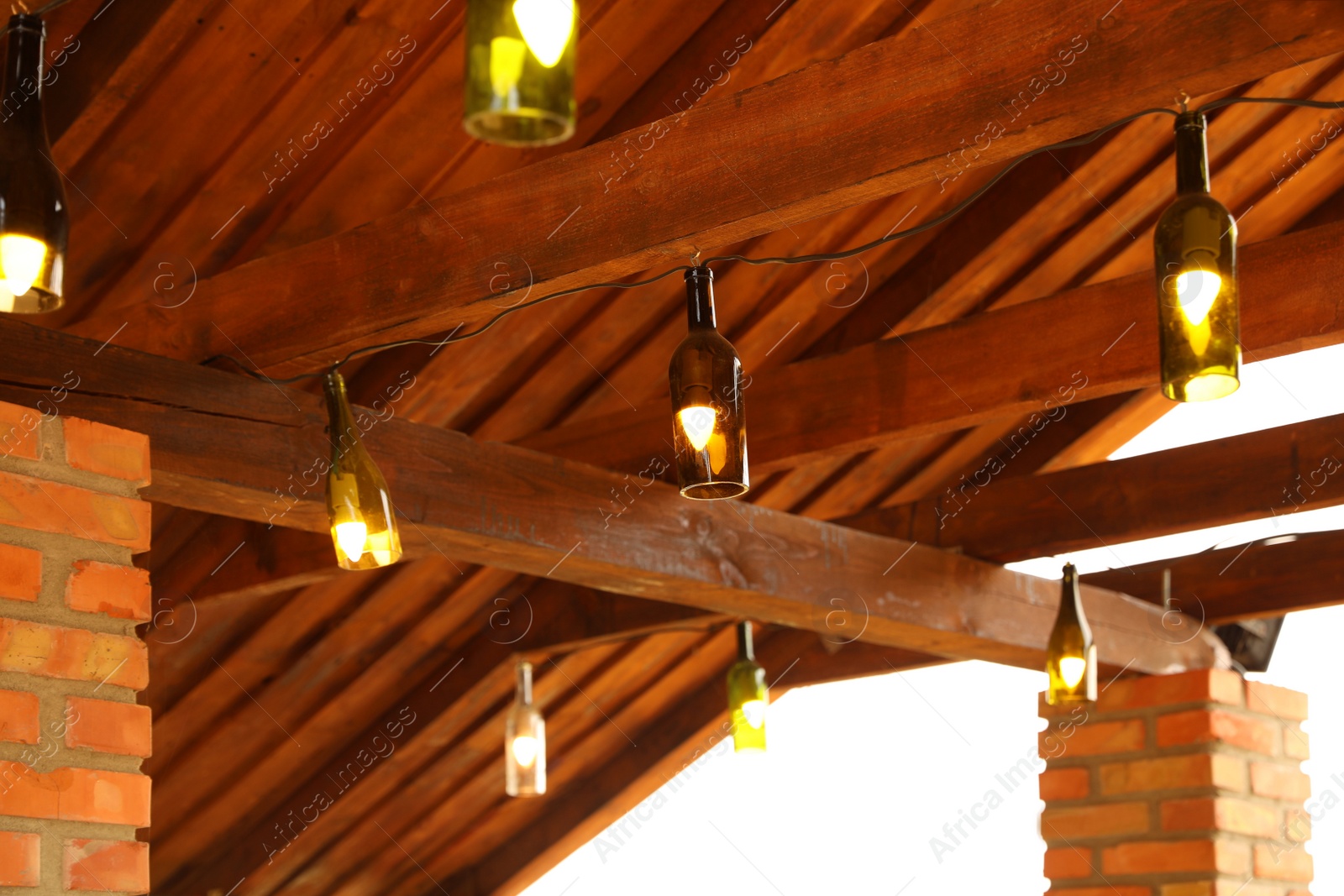 Photo of Creative pendant lamps with light bulbs indoors