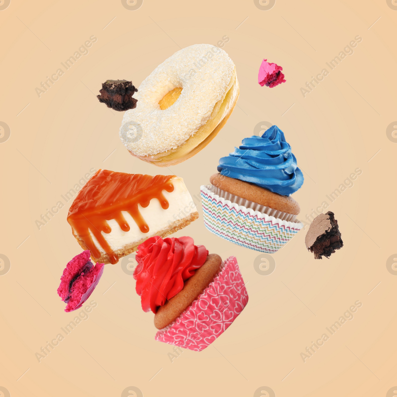 Image of Many different tasty desserts flying on beige background