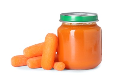 Photo of Tasty baby food in jar and fresh carrots isolated on white