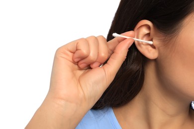 Woman cleaning ear with cotton swab on white background, closeup