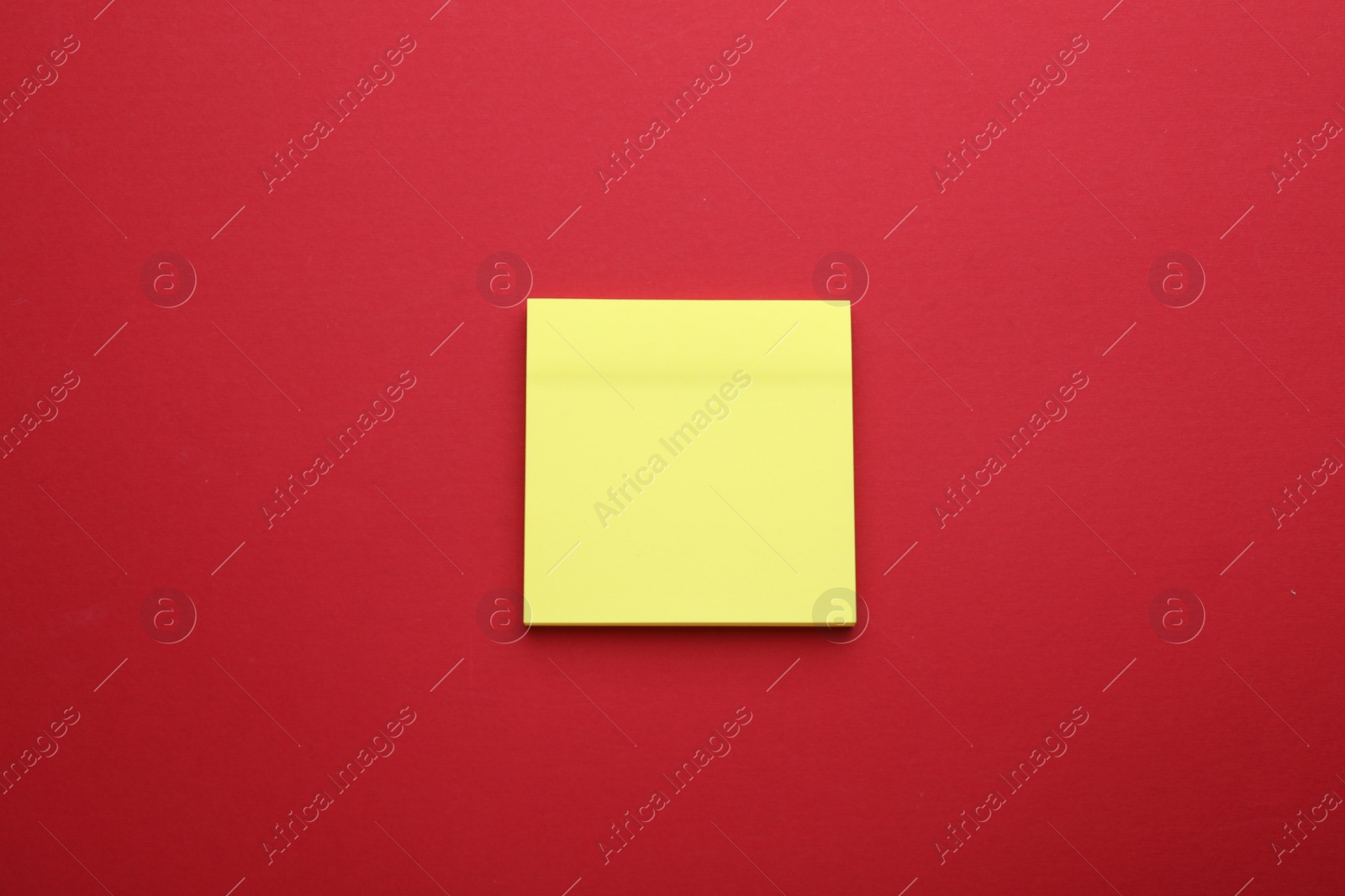 Photo of Paper note on red background, top view
