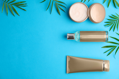 Flat lay composition with cosmetic products on blue background. Space for text