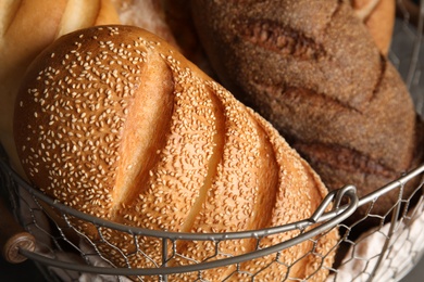 Different kinds of fresh bread in basket, closeup