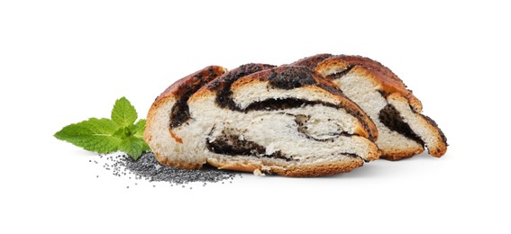 Slices of poppy seed roll and mint leaves isolated on white. Tasty cake