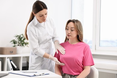 Photo of Mammologist checking young woman's breast in hospital