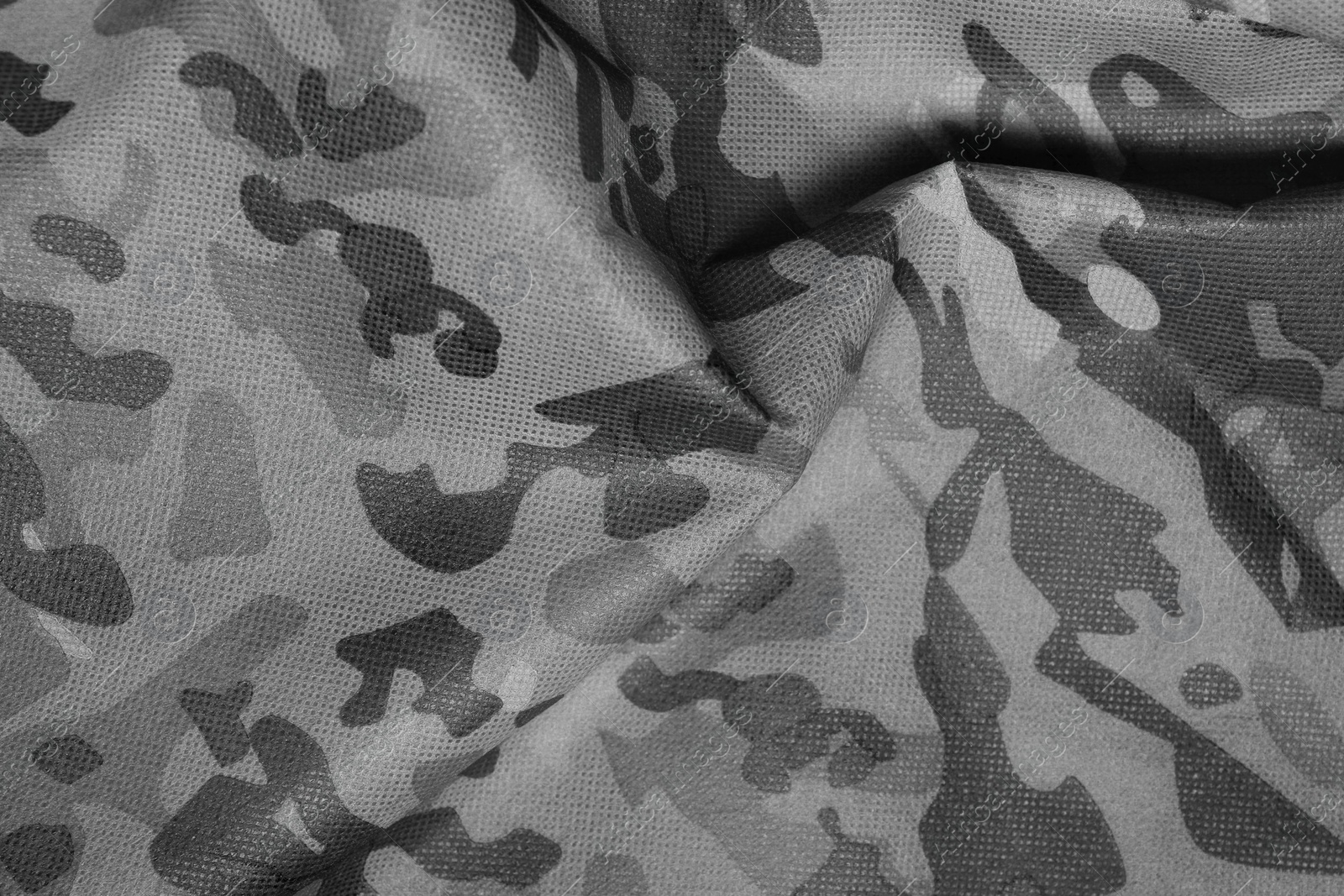 Image of Texture of crumpled camouflage fabric as background, top view. Black and white effect