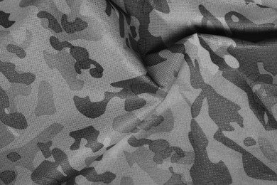 Image of Texture of crumpled camouflage fabric as background, top view. Black and white effect