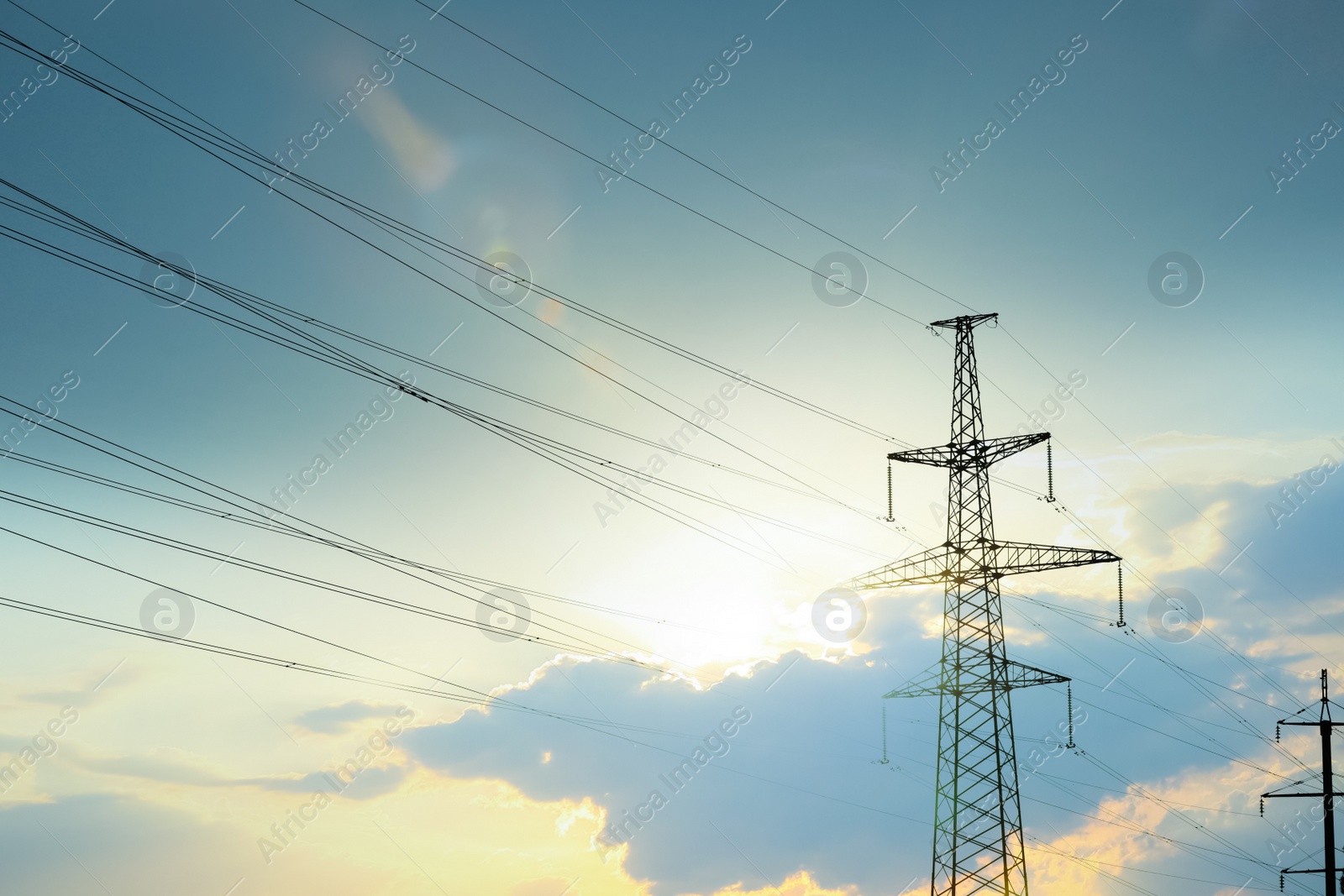 Photo of Telephone pole with cables under blue sky outdoors