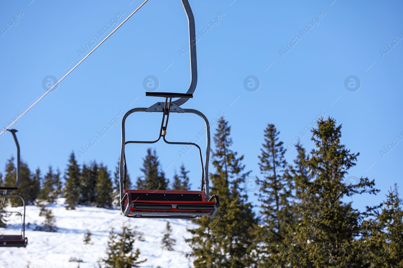 Photo of Empty chairlift at mountain ski resort. Winter vacation